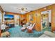 Living room displaying wood paneling with easy access to kitchen at 530 Mckenzie Rd, Lake Helen, FL 32744