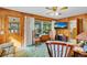 Cozy living room with wood paneled walls and a large window at 530 Mckenzie Rd, Lake Helen, FL 32744