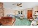 Inviting living room with sofas, a ceiling fan, and a front door, creating a comfortable gathering space at 530 Mckenzie Rd, Lake Helen, FL 32744