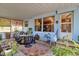 View of a screened patio with brick floor and outdoor furniture at 530 Mckenzie Rd, Lake Helen, FL 32744
