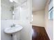 Bathroom featuring a pedestal sink, a decorative mirror, and access to a bedroom at 5619 Pinerock Rd, Orlando, FL 32810