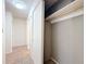 Hallway with tiled floor, closet with custom shelving and rod, and access to other rooms at 5619 Pinerock Rd, Orlando, FL 32810