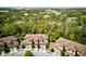 Aerial view of townhomes showing roof lines in lush wooded area near community at 8141 Roseville Blvd, Davenport, FL 33896