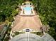 Aerial view of a community clubhouse and pool surrounded by lush greenery at 8141 Roseville Blvd, Davenport, FL 33896