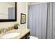 Well-maintained bathroom featuring granite countertops and a framed mirror at 8141 Roseville Blvd, Davenport, FL 33896