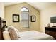 Bedroom featuring vaulted ceilings, matching artwork, neutral paint, and a dresser with decor at 8141 Roseville Blvd, Davenport, FL 33896