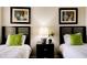 Bedroom featuring twin beds, matching artwork, neutral paint, and a bedside table with lamp at 8141 Roseville Blvd, Davenport, FL 33896