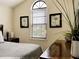 Bedroom featuring vaulted ceilings, matching artwork, neutral paint, and a dresser with decor at 8141 Roseville Blvd, Davenport, FL 33896