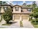 Charming townhome with a terra cotta tile roof and two-car garage, with a brick paver driveway at 8141 Roseville Blvd, Davenport, FL 33896