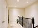 Upstairs hallway featuring carpeted floors, neutral paint, a plant, and doors to other rooms at 8141 Roseville Blvd, Davenport, FL 33896