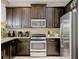Well-equipped kitchen with stainless steel appliances and dark wood cabinets at 8141 Roseville Blvd, Davenport, FL 33896