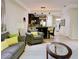 Comfortable living room with neutral tones and access to dining area at 8141 Roseville Blvd, Davenport, FL 33896