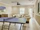 Community lounge area with comfortable sofas, a TV, and a ping pong table at 8141 Roseville Blvd, Davenport, FL 33896