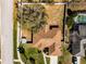 Aerial view of a home with a large, fenced backyard, mature trees, and a well-maintained roof at 600 Park Valley Cir, Minneola, FL 34715