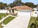 Attractive home with a well-kept lawn, mature trees and an attached garage at 600 Park Valley Cir, Minneola, FL 34715