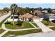 Inviting home with lush lawn, mature palm, and a white fenced yard at 600 Park Valley Cir, Minneola, FL 34715