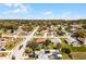 An aerial view of a residential neighborhood featuring well-manicured lawns and mature trees at 600 Park Valley Cir, Minneola, FL 34715