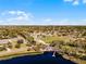The aerial view shows the neighborhood homes near the lake and community field at 600 Park Valley Cir, Minneola, FL 34715