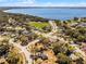 Aerial view of a residential neighborhood with the lake in the distance on a clear, sunny day at 600 Park Valley Cir, Minneola, FL 34715