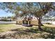 Spacious backyard features a screened patio and mature trees, offering shade and privacy at 600 Park Valley Cir, Minneola, FL 34715