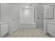 Bathroom features a large soaking tub with a glass enclosed shower and tile flooring at 600 Park Valley Cir, Minneola, FL 34715