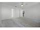 Bright bedroom features neutral carpet, ceiling fan, and access to a walk in shower and partial kitchen at 600 Park Valley Cir, Minneola, FL 34715
