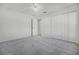 Bright bedroom features neutral carpet, ceiling fan, and a closet at 600 Park Valley Cir, Minneola, FL 34715