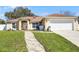 Charming home features a welcoming walkway and a well-maintained lawn at 600 Park Valley Cir, Minneola, FL 34715