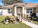 Inviting home features a koi pond and a charming bridge to the front door at 600 Park Valley Cir, Minneola, FL 34715