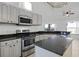 Well-equipped kitchen with stainless steel appliances and granite countertops at 600 Park Valley Cir, Minneola, FL 34715