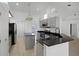 Bright kitchen features stainless steel appliances, modern cabinets, and granite countertops with an island at 600 Park Valley Cir, Minneola, FL 34715
