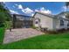 The home's exterior displays a screened-in pool and patio area, complemented by lush lawn at 1008 Turtle Creek Dr, Oviedo, FL 32765