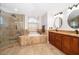 Luxurious bathroom features a glass shower, soaking tub, double vanities, and elegant tile work at 1008 Turtle Creek Dr, Oviedo, FL 32765