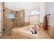 Elegant bathroom featuring a tiled shower, separate soaking tub and a large window letting in natural light at 1008 Turtle Creek Dr, Oviedo, FL 32765