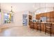 Dining room with a view to the kitchen with breakfast bar and a screened lanai at 1008 Turtle Creek Dr, Oviedo, FL 32765