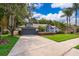 Charming single-story home with a well-manicured lawn, driveway, and mature landscaping at 1008 Turtle Creek Dr, Oviedo, FL 32765