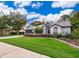 Charming single-story home with a well-manicured lawn and lush landscaping at 1008 Turtle Creek Dr, Oviedo, FL 32765