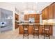 Bright kitchen with stainless appliances, granite countertops, and an island with bar stool seating at 1008 Turtle Creek Dr, Oviedo, FL 32765