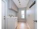 Convenient laundry room featuring overhead storage, a utility sink, and tile flooring at 1008 Turtle Creek Dr, Oviedo, FL 32765