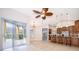Open-concept living area with sliding doors to the lanai and a view of the modern kitchen with breakfast bar at 1008 Turtle Creek Dr, Oviedo, FL 32765