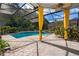 Screened-in pool with a spa and a beautiful outdoor living area with bright curtains at 1008 Turtle Creek Dr, Oviedo, FL 32765