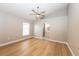 Spacious bedroom features an ensuite bathroom, ceiling fan and beautiful hardwood floors at 10142 Richardson Ct, Orlando, FL 32825