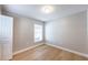 Neutral bedroom with wood floors, white trim, and a window at 10142 Richardson Ct, Orlando, FL 32825