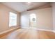 Spacious bedroom features an ensuite bathroom, ceiling fan and beautiful hardwood floors at 10142 Richardson Ct, Orlando, FL 32825