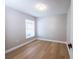 Bedroom featuring neutral walls, wood floors, a window and minimalist design at 10142 Richardson Ct, Orlando, FL 32825