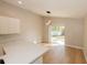 Open dining area adjacent to kitchen with modern pendant lighting and sliding glass door to backyard at 10142 Richardson Ct, Orlando, FL 32825