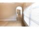 Bright hallway featuring hardwood floors and archway architectural details at 10142 Richardson Ct, Orlando, FL 32825