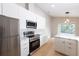 Bright kitchen features stainless appliances and ample white counter space at 10142 Richardson Ct, Orlando, FL 32825