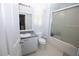 Bright bathroom featuring a shower-tub combo with sliding glass doors and a vanity with a gray countertop at 1020 Siena Park W Blvd # 103, Celebration, FL 34747