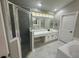 Bathroom featuring walk in shower, soaking tub, and dual sink vanity at 10446 Stone Glen Dr, Orlando, FL 32825